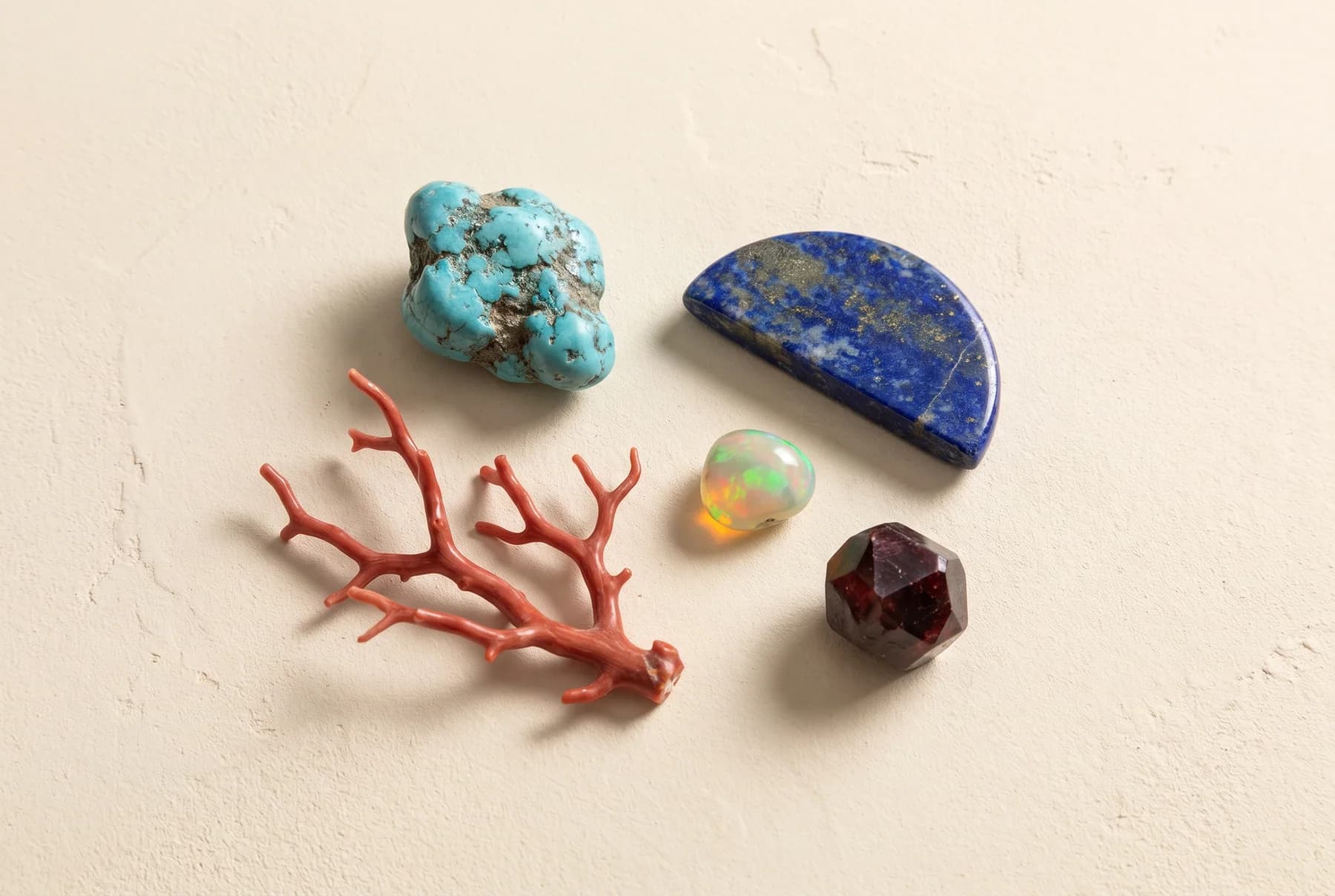 Raw turquoise, coral, lapis lazuli, opal and garnet on cream plaster